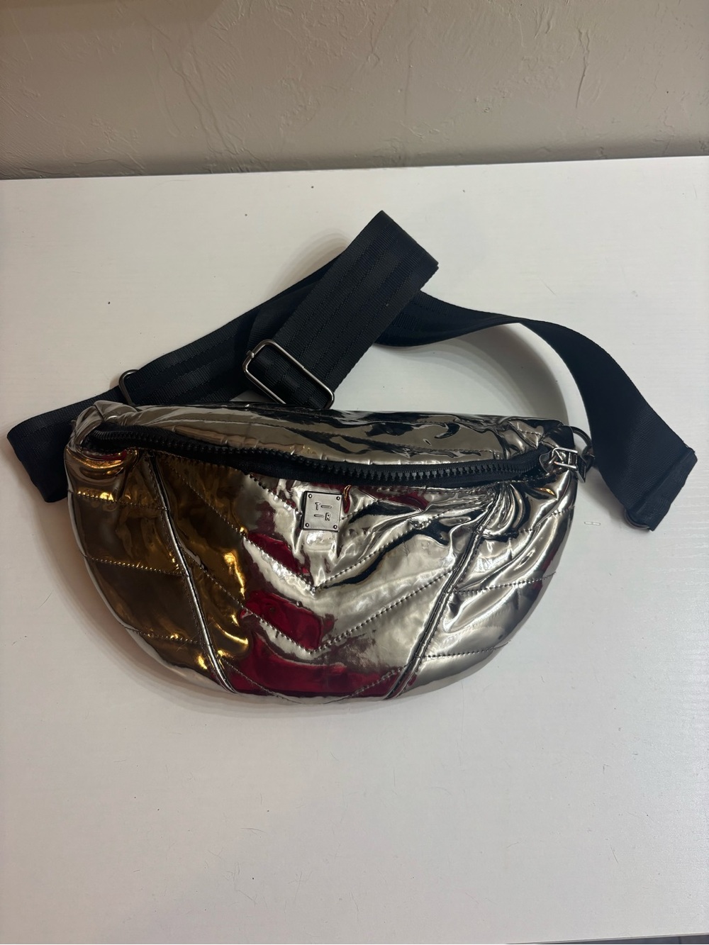 THINK ROYLN Metallic Silver Quilted Crossbody Belt Bag with Black Strap